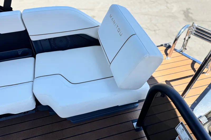 Slide: The Image of Luxury seating on 2025 Manitou EXPLORE 26 boat with white upholstery and sleek design. - 20