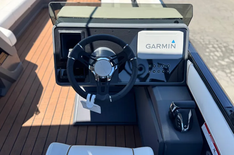 Slide: The Image of Steering console of 2025 Manitou EXPLORE 26 boat with Garmin navigation system. - 24