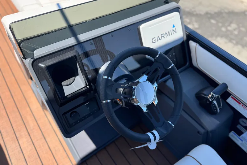 Slide: The Image of Steering console of 2025 Manitou EXPLORE 26 boat with Garmin navigation system. - 25