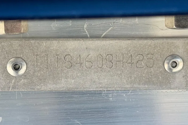 Slide: The Image of Serial number plate on 2025 Manitou EXPLORE 26, featuring engraved identification code. - 27