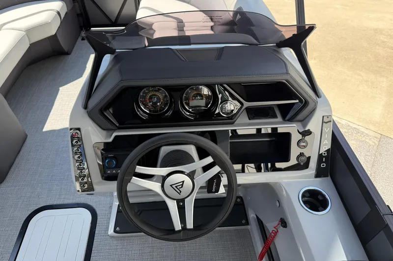 Slide: The Image of 2026 Viaggio Lago X-C boat dashboard with steering wheel and control panel. - 7