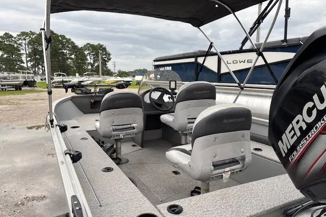 Slide: The Image of 2014 Alumacraft Escape 165 CS boat with Mercury engine, featuring dual seats and steering console. - 11