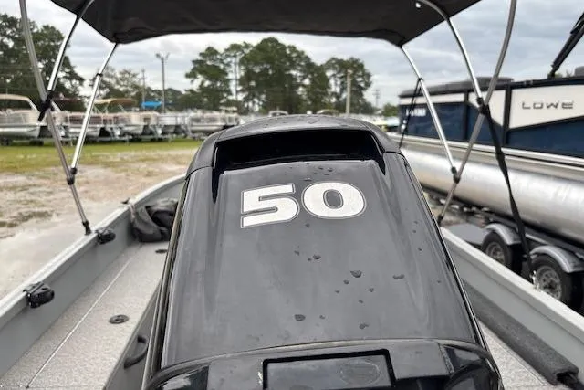 Slide: The Image of 2014 Alumacraft Escape 165 CS boat with 50 HP engine, parked outdoors. - 12