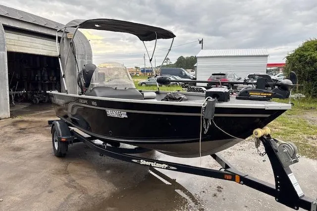 Slide: The Image of 2014 Alumacraft Escape 165 CS boat on trailer, parked outdoors. - 3
