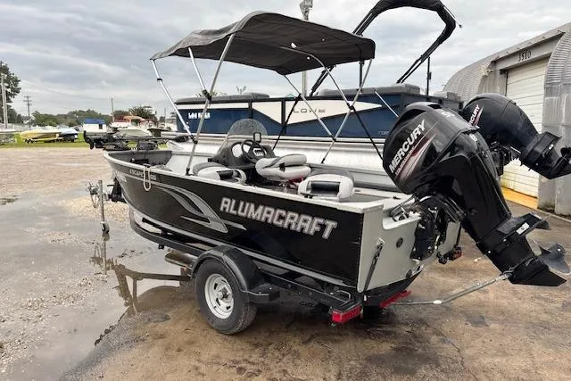 Slide: The Image of 2014 Alumacraft Escape 165 CS boat with Mercury outboard motor on trailer. - 5