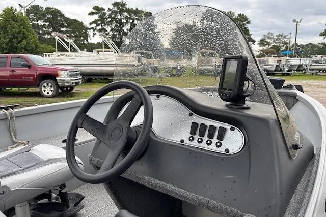 Slide: The Image of 2014 Alumacraft Escape 165 CS boat dashboard with steering wheel and control panel. - 7