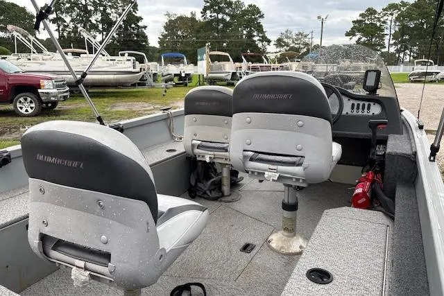 Slide: The Image of 2014 Alumacraft Escape 165 CS boat interior with two seats and fishing gear. - 8