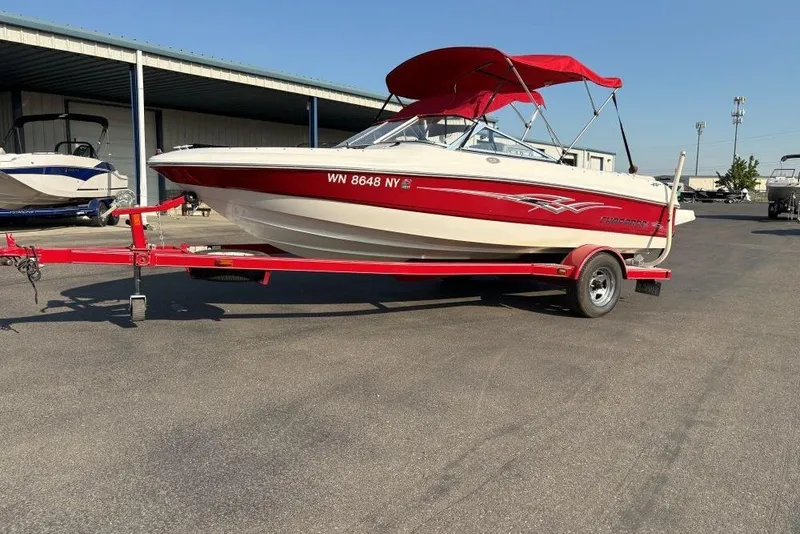 The Image of 2008 Chaparral 180 SSi boat with red accents on a trailer, parked outdoors. - 1