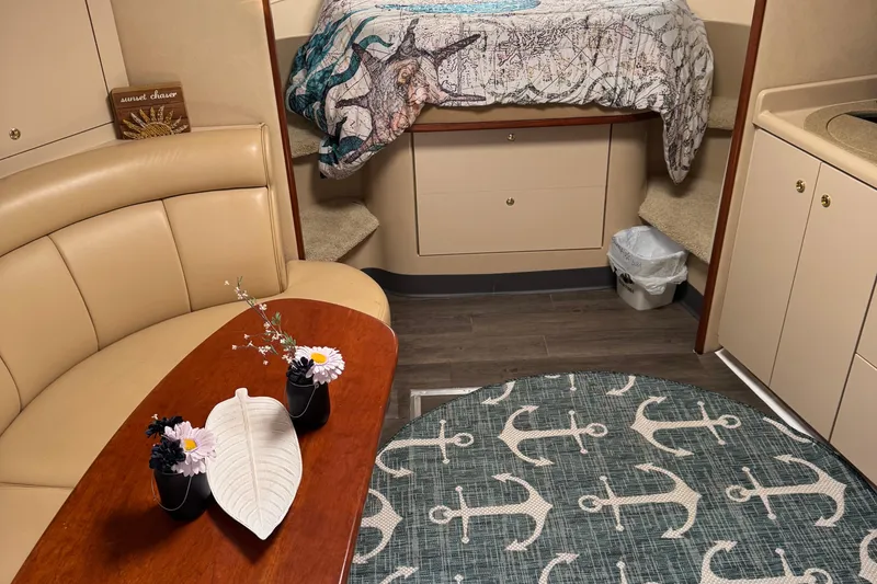 Slide: The Image of Interior of 2000 Cruisers Yachts 3870 Express with cozy seating and nautical decor. - 11