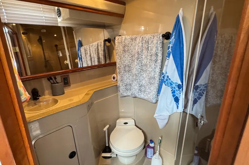 Slide: The Image of Bathroom interior of 2000 Cruisers Yachts 3870 Express with sink, toilet, and shower. - 14