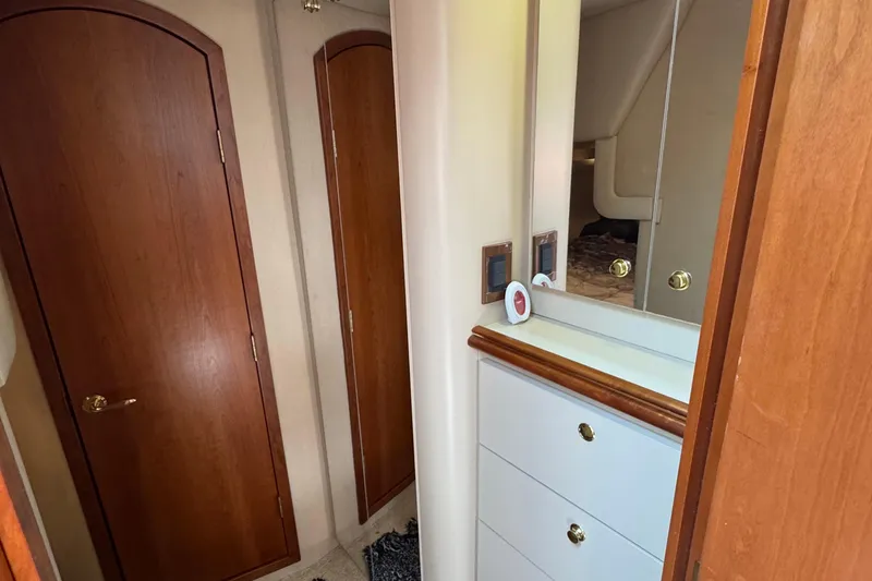 Slide: The Image of Interior of 2000 Cruisers Yachts 3870 Express with wooden doors and mirrored cabinet. - 15