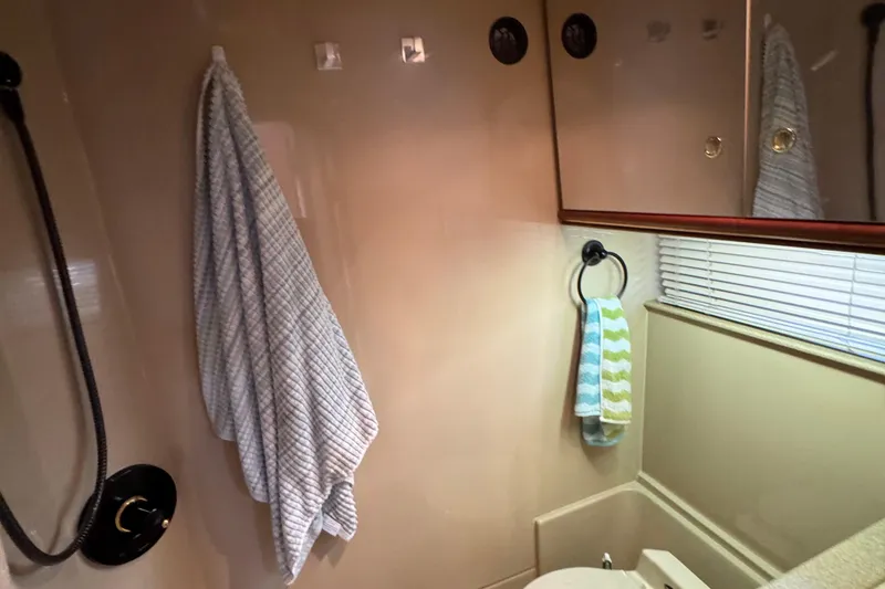 Slide: The Image of Bathroom interior of 2000 Cruisers Yachts 3870 Express with towels and mirror. - 16