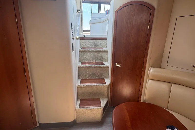 Slide: The Image of Interior of 2000 Cruisers Yachts 3870 Express with stairs and wooden door. - 17