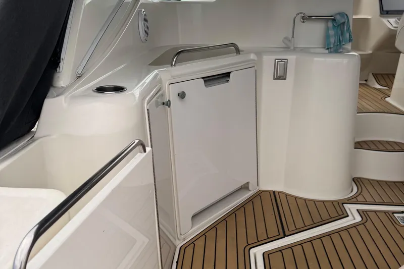 Slide: The Image of 2000 Cruisers Yachts 3870 Express interior with sleek cabinetry and wood-patterned flooring. - 2