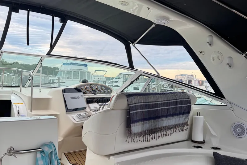 Slide: The Image of Interior of 2000 Cruisers Yachts 3870 Express with helm, controls, and seating. - 4