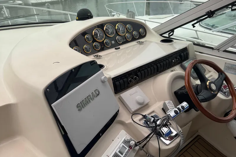 Slide: The Image of Helm of 2000 Cruisers Yachts 3870 Express with Simrad navigation system and wooden steering wheel. - 6