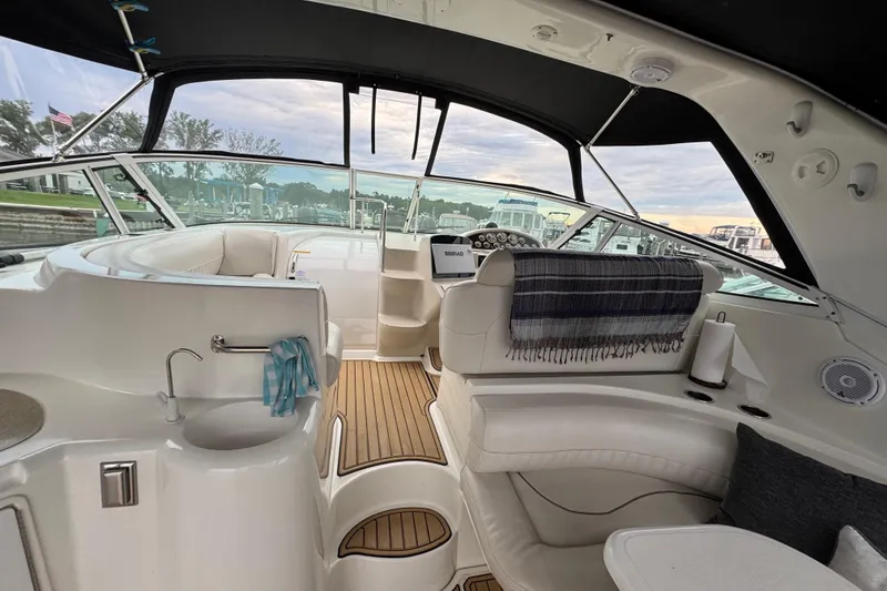 Slide: The Image of Interior of 2000 Cruisers Yachts 3870 Express with elegant seating and helm station. - 9