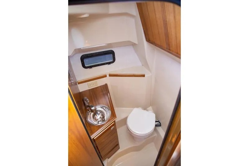 Slide: The Image of Manufacturer Provided Image: 2025 Ranger Tugs R-25 boat bathroom with sink and toilet. - 11