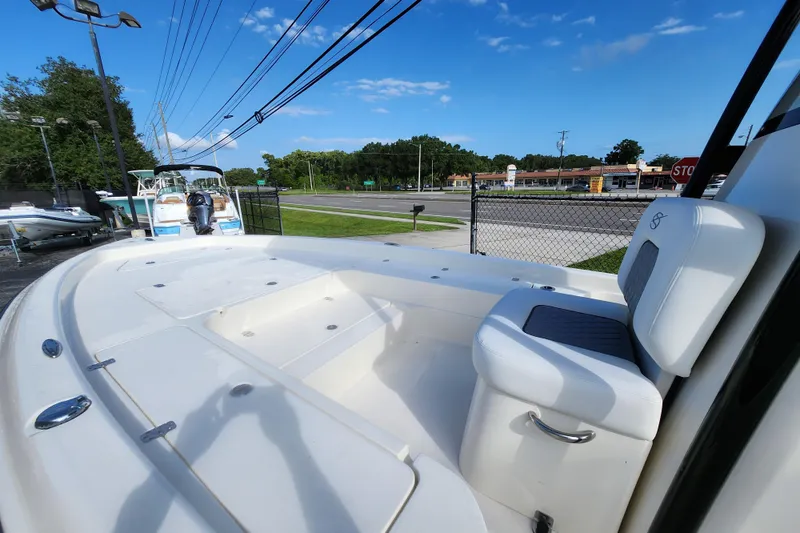Slide: The Image of 2026 ShearWater 25 LTD boat with seating, parked outdoors under a clear blue sky. - 10