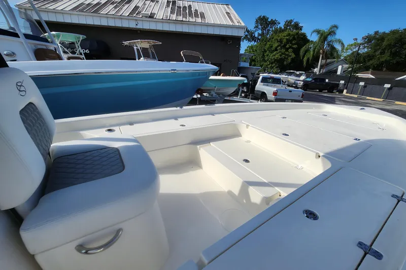 Slide: The Image of 2026 ShearWater 25 LTD boat interior with seating and storage compartments. - 11