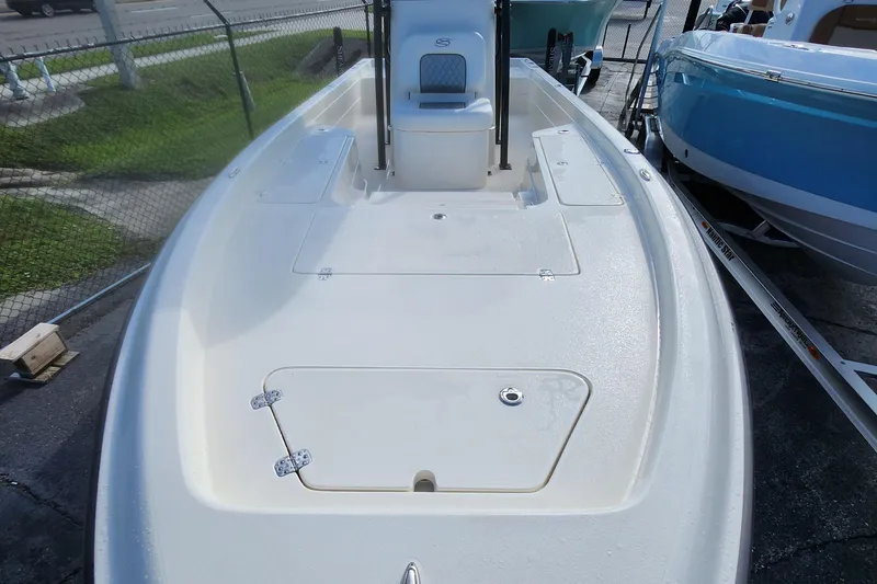 Slide: The Image of 2026 ShearWater 25 LTD boat deck, white finish, parked on trailer. - 12