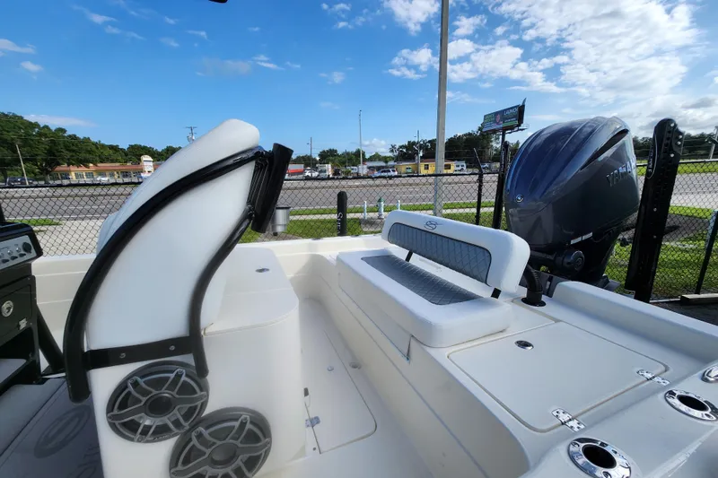 Slide: The Image of 2026 ShearWater 25 LTD boat interior with seating and Yamaha outboard motor. - 2