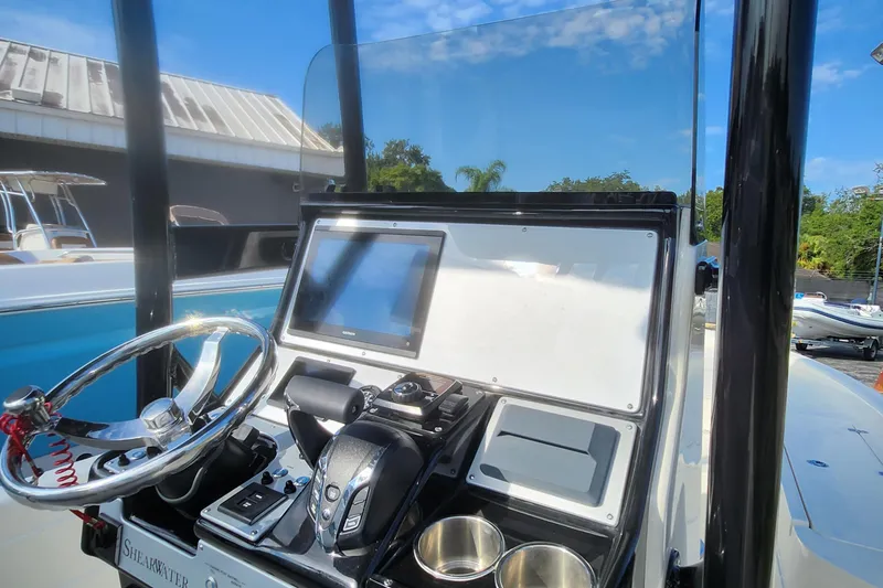 Slide: The Image of ShearWater 25 LTD 2026 boat dashboard with steering wheel and navigation display. - 8