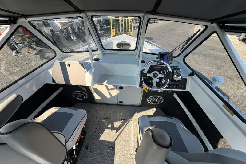 Slide: The Image of 2006 North River 21 Commander 212 Pump boat interior with steering wheel and seating. - 6