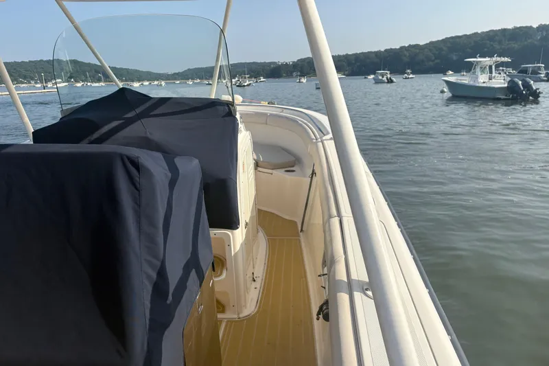 Slide: The Image of 2011 Pursuit S 280 Sport boat on calm water, surrounded by other boats. - 10