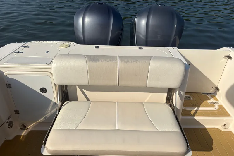 Slide: The Image of 2011 Pursuit S 280 Sport boat with dual engines and cushioned seating. - 16