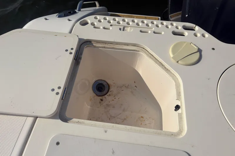 Slide: The Image of Open storage compartment on 2011 Pursuit S 280 Sport boat deck. - 18