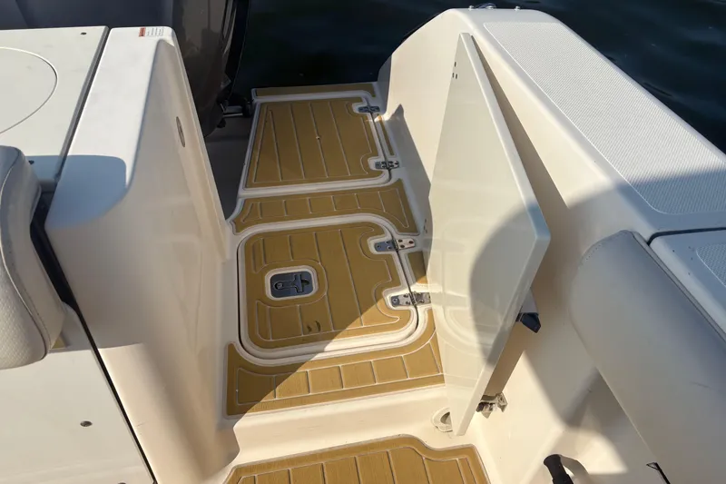 Slide: The Image of 2011 Pursuit S 280 Sport boat deck with open hatch and seating area. - 21