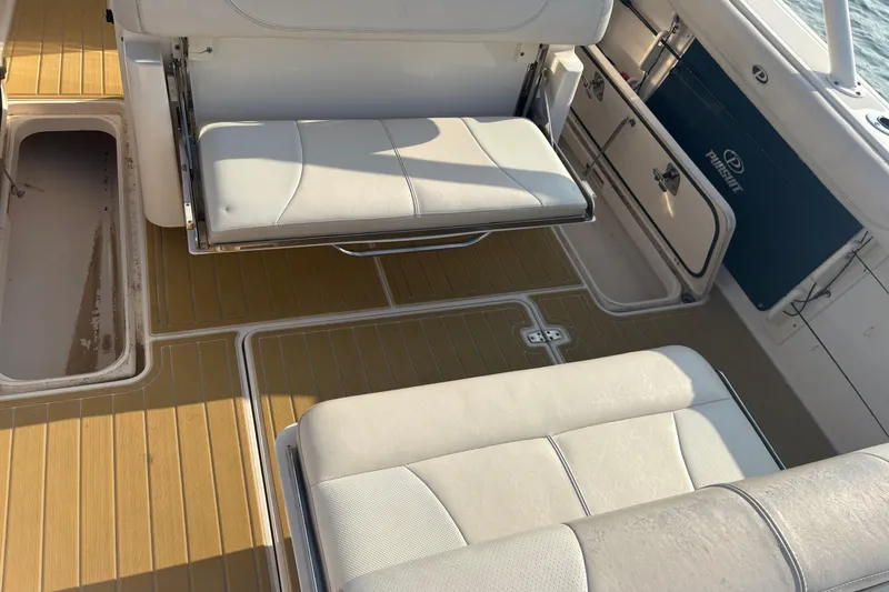 Slide: The Image of Interior of 2011 Pursuit S 280 Sport boat with cushioned seating and storage compartments. - 24