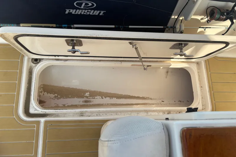 Slide: The Image of Open storage compartment on 2011 Pursuit S 280 Sport boat deck. - 26