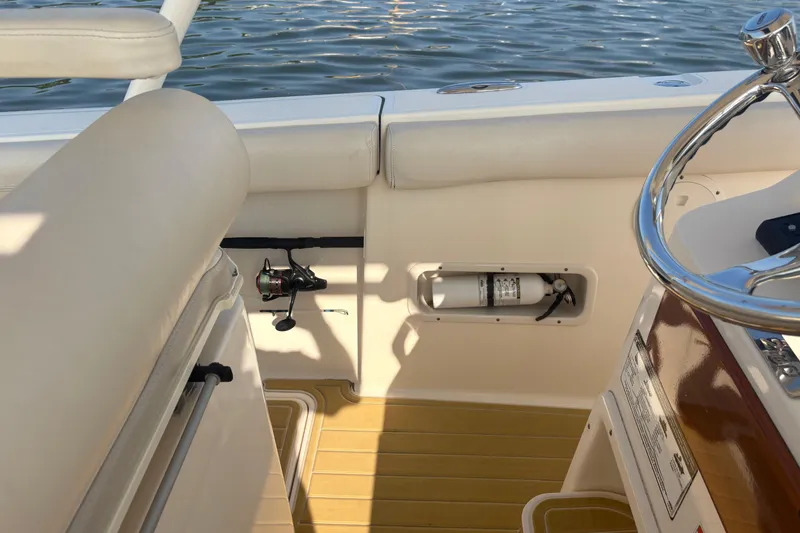 Slide: The Image of Interior of 2011 Pursuit S 280 Sport boat with fishing rod and fire extinguisher. - 29
