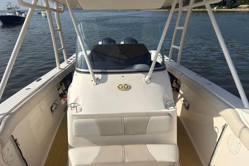Slide: The Image of 2011 Pursuit S 280 Sport boat interior with seating and console on calm water. - 37