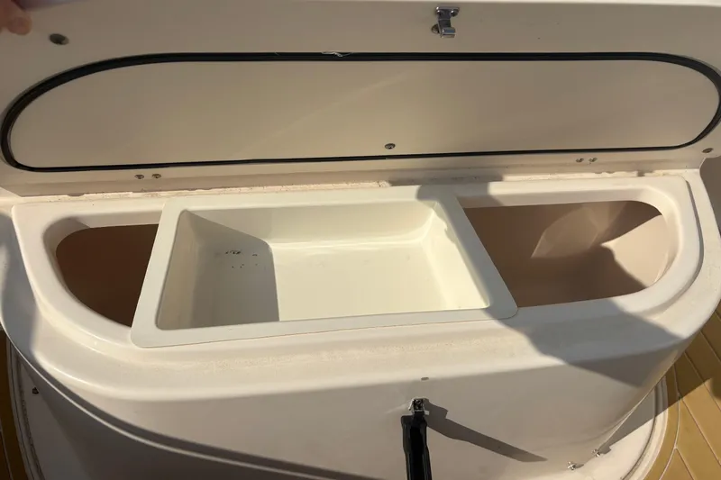 Slide: The Image of Open storage compartment on a 2011 Pursuit S 280 Sport boat. - 38