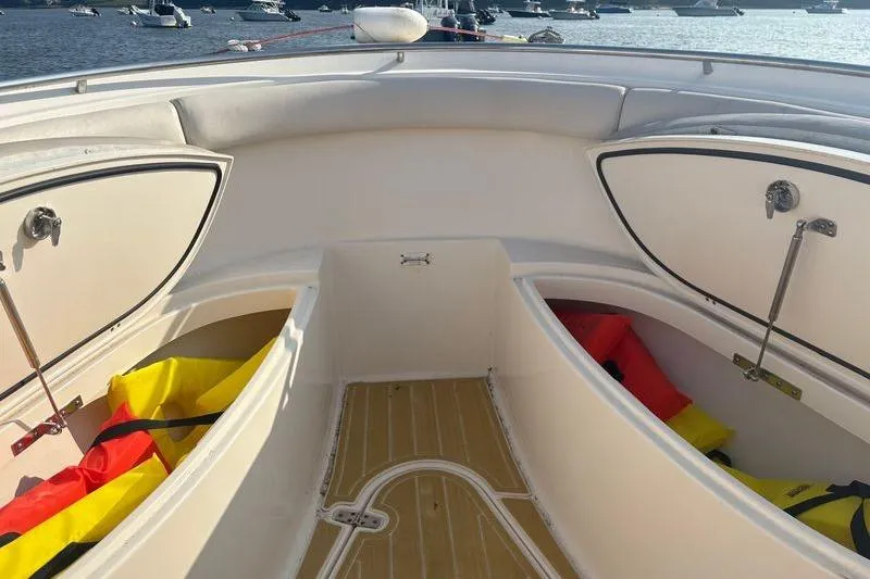 Slide: The Image of 2011 Pursuit S 280 Sport boat interior with open storage compartments and life jackets. - 42