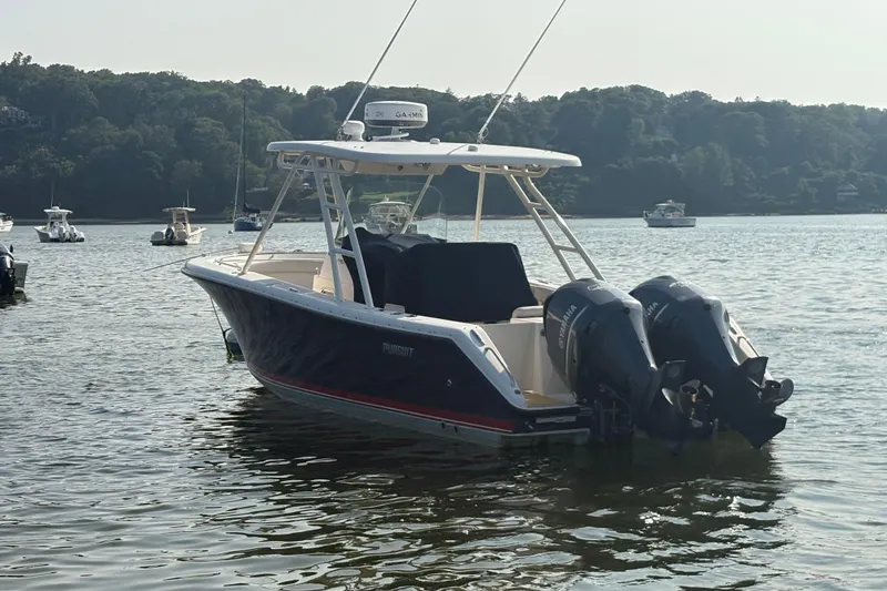 Slide: The Image of 2011 Pursuit S 280 Sport boat with dual engines on a calm lake. - 5