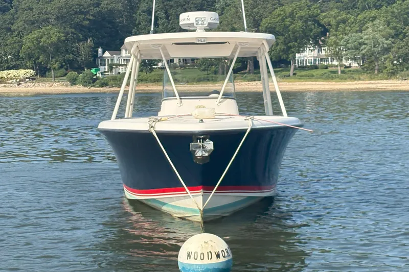 Slide: The Image of 2011 Pursuit S 280 Sport boat anchored near a scenic shoreline. - 6