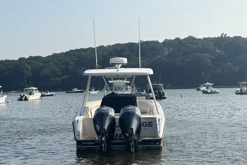 Slide: The Image of 2011 Pursuit S 280 Sport boat with dual engines on a calm lake. - 7