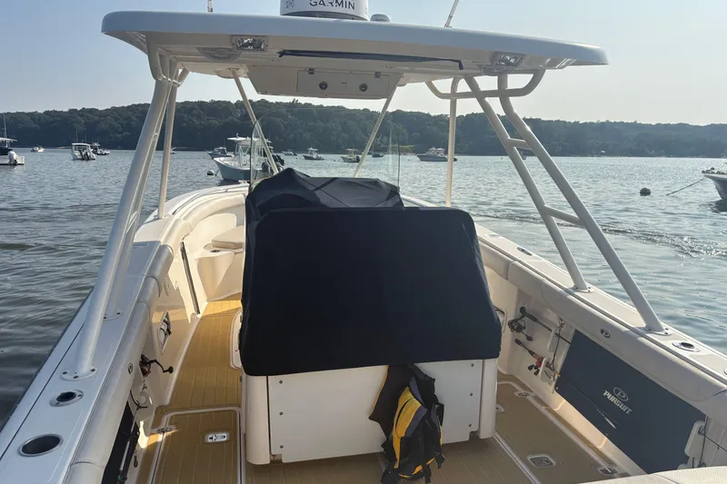 Slide: The Image of 2011 Pursuit S 280 Sport boat on calm water, featuring a spacious deck and modern design. - 8