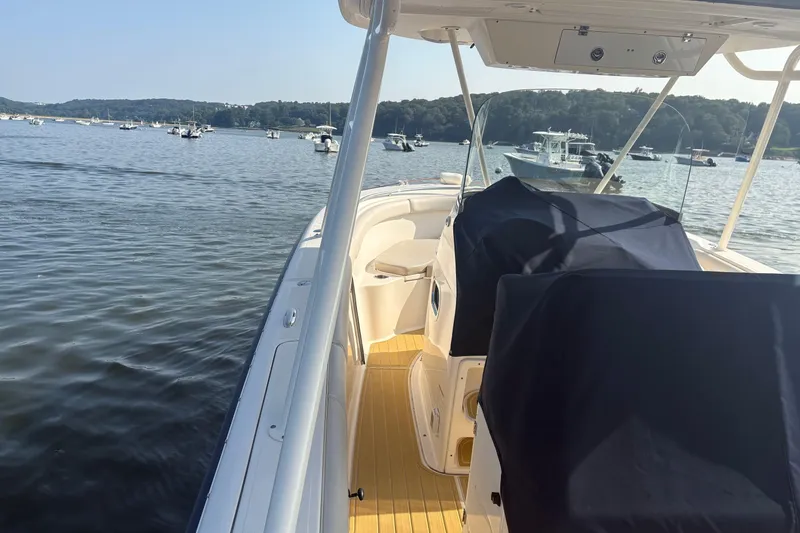 Slide: The Image of 2011 Pursuit S 280 Sport boat on calm water with scenic background. - 9