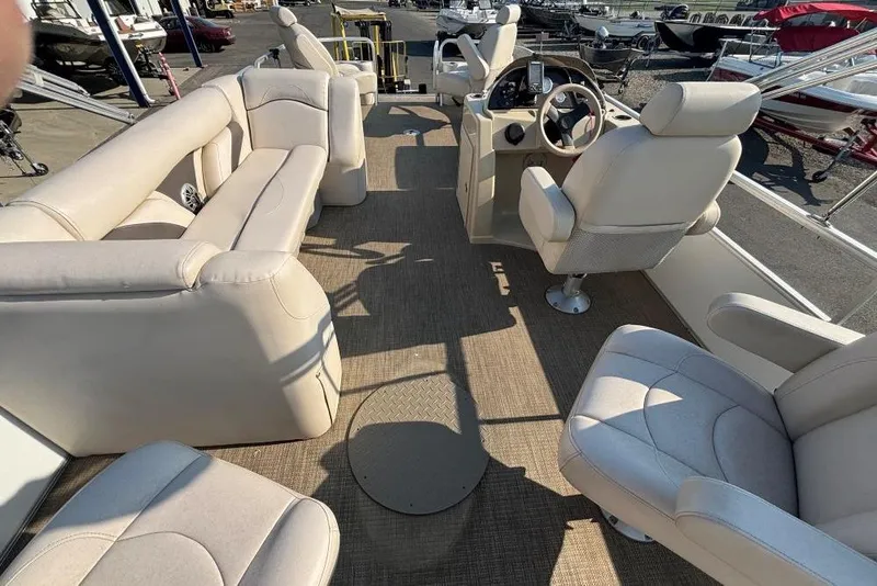 Slide: The Image of 2016 SunChaser Classic Fish 8522 DLX pontoon boat interior with beige seating and steering console. - 10