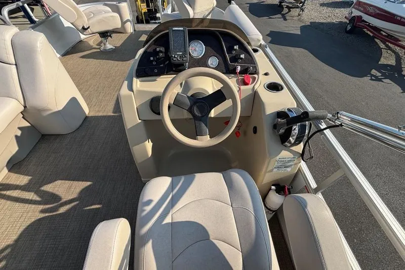 Slide: The Image of 2016 SunChaser Classic Fish 8522 DLX boat interior with steering console and seating. - 11