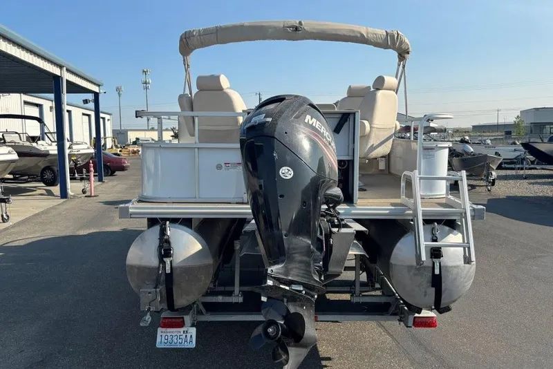 Slide: The Image of 2016 SunChaser Classic Fish 8522 DLX pontoon boat with Mercury outboard motor, parked outdoors. - 3