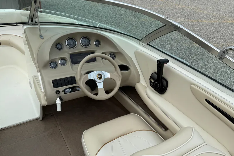 Slide: The Image of Interior view of a 1998 Sea Ray 190 Bow Rider boat dashboard and steering wheel. - 10