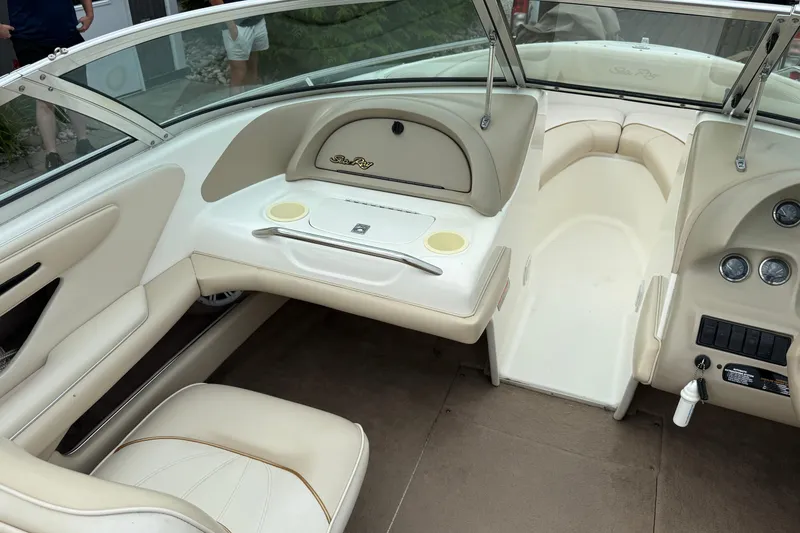 Slide: The Image of 1998 Sea Ray 190 Bow Rider interior with beige seating and dashboard. - 11