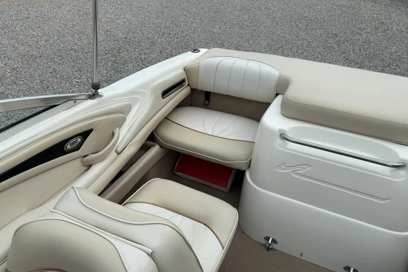 Slide: The Image of 1998 Sea Ray 190 Bow Rider interior with beige seating and sleek design. - 13