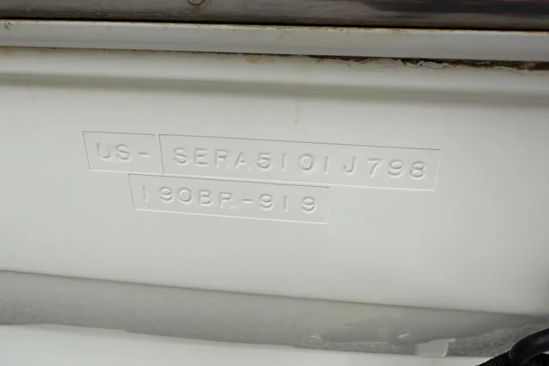 Slide: The Image of 1998 Sea Ray 190 Bow Rider hull identification number embossed on white surface. - 17